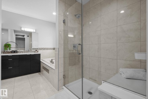 Glass-enclosed shower with a built-in bench - 2019 Ware Rd Nw, Edmonton, AB 