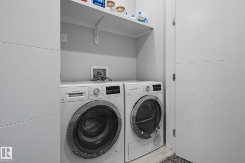 White built-in shelving, light gray wall color, and a white interior door with horizontal paneling - 2019 Ware Rd Nw, Edmonton, AB 