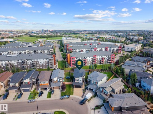 Residential property featuring a paved driveway, attached garage, and a fenced backyard - 2019 Ware Rd Nw, Edmonton, AB 
