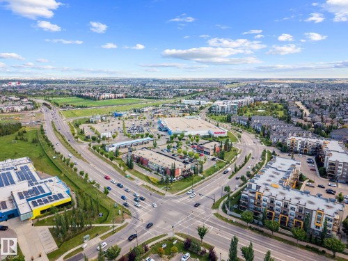 Aerial perspective of a developed urban area featuring multiple commercial buildings, residential structures, and intersecting roadways - 2019 Ware Rd Nw, Edmonton, AB 