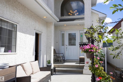 Inviting entryway featuring a white glass-paneled door, arched window, and recessed lighting - 6407 163 Avenue Nw, Edmonton, AB 