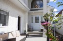 Inviting entryway featuring a white glass-paneled door, arched window, and recessed lighting - 6407 163 Avenue Nw, Edmonton, AB 