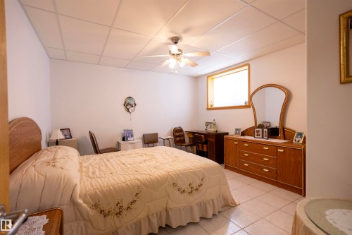 Neutral white walls with a drop ceiling featuring integrated lighting and a ceiling fan - 6407 163 Avenue Nw, Edmonton, AB 