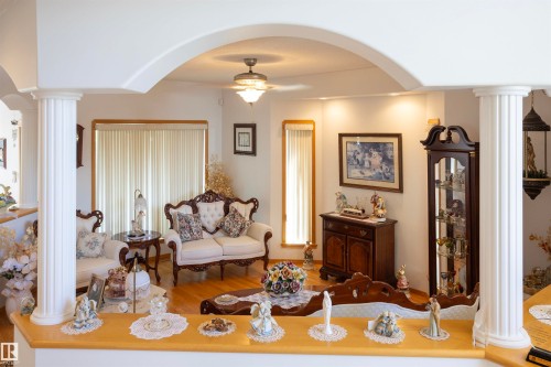 Archway entry featuring fluted columns and wood-finish flooring - 6407 163 Avenue Nw, Edmonton, AB 