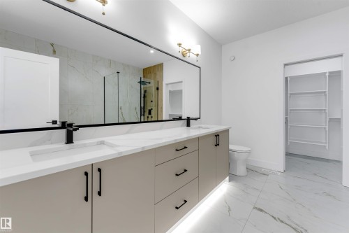 Dual vanity with integrated sinks and black matte fixtures - 4234 63 Street, Beaumont, AB - Indoor Photo Showing Bathroom