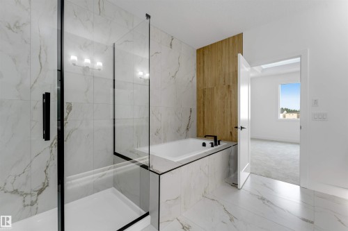 Spacious bathroom featuring marble-look tile flooring and wall surrounds, a built-in soaking tub with black fixtures, and a glass-enclosed shower with black framing - 4234 63 Street, Beaumont, AB - Indoor Photo Showing Bathroom