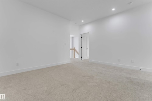 Carpeted room featuring white walls, recessed lighting, and white baseboards - 4234 63 Street, Beaumont, AB - Indoor Photo Showing Other Room