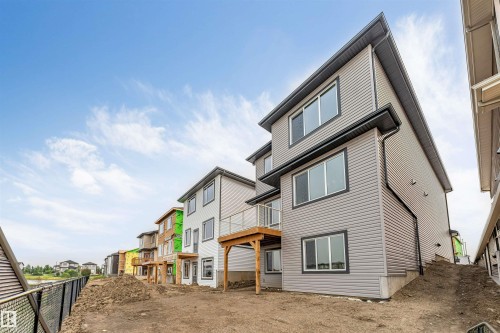 Gray multi-story exterior with horizontal siding and dark trim windows - 4234 63 Street, Beaumont, AB - Outdoor