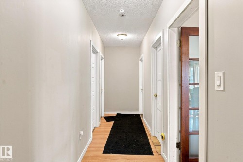 Wood-finish flooring throughout the hallway - 11008 109 Street Nw, Edmonton, AB 