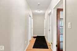 Wood-finish flooring throughout the hallway - 