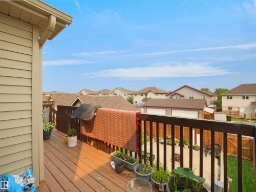 Elevated outdoor deck with wood-finish flooring and railing - 1216 29 Avenue Nw, Edmonton, AB - Outdoor With Deck Patio Veranda With Exterior