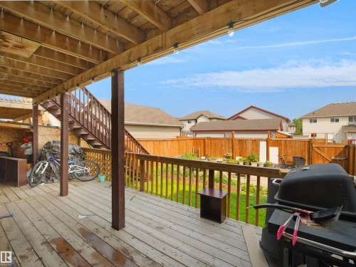 Expansive wood-finish deck with integrated staircase, providing direct outdoor access - 1216 29 Avenue Nw, Edmonton, AB - Outdoor With Deck Patio Veranda With Exterior