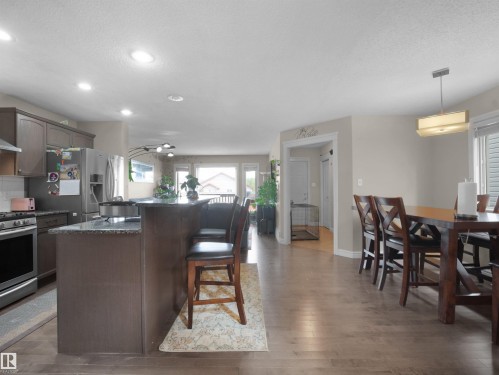 Open-concept kitchen and dining area with hardwood-style flooring - 1216 29 Avenue Nw, Edmonton, AB - Indoor