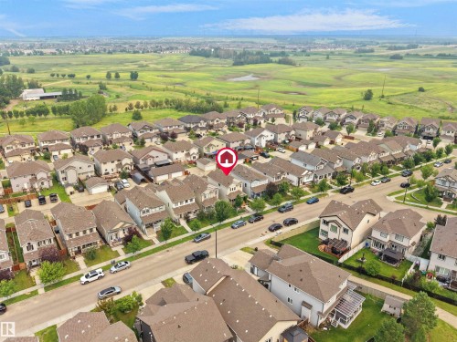 Residential neighborhood featuring a grid-pattern street layout, uniformly designed homes, and a distant green landscape - 1216 29 Avenue Nw, Edmonton, AB - Outdoor With View