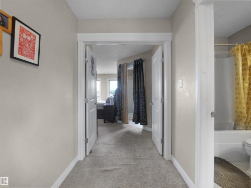 Hallway with neutral wall paint and light-colored carpet flooring - 1216 29 Avenue Nw, Edmonton, AB - Indoor Photo Showing Other Room