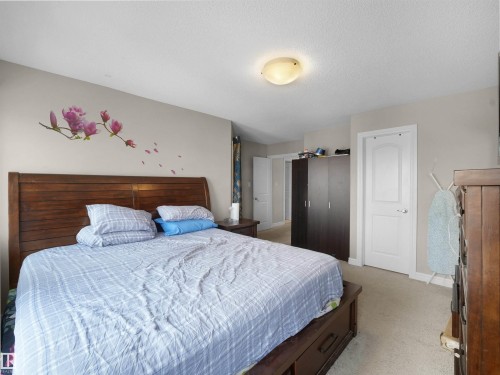 Spacious bedroom featuring light-toned walls and neutral carpeting - 1216 29 Avenue Nw, Edmonton, AB - Indoor Photo Showing Bedroom
