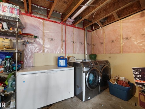 Unfinished basement space featuring exposed wood joists, insulated walls, and concrete flooring - 1216 29 Avenue Nw, Edmonton, AB - Indoor Photo Showing Laundry Room