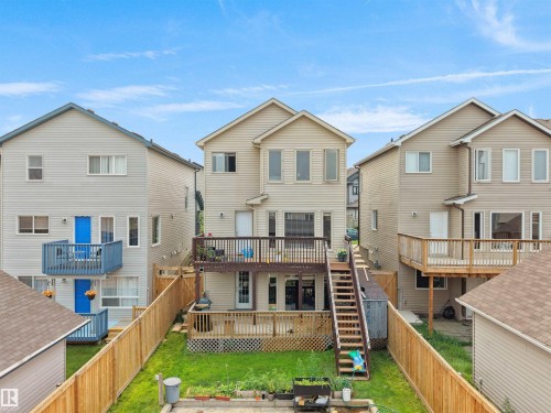 Multi-level deck and patio area featuring wood railings and stairs - 1216 29 Avenue Nw, Edmonton, AB - Outdoor With Deck Patio Veranda
