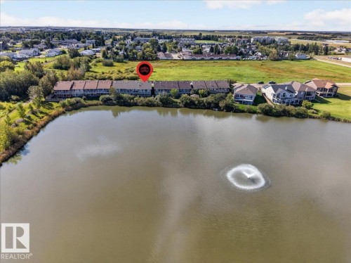 Waterfront townhouse property featuring a private lake, a water feature, and direct water access - #7 10500 103 Av, Morinville, AB 