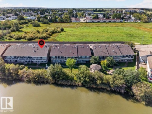 Townhouse property with multiple balconies overlooking a body of water - #7 10500 103 Av, Morinville, AB 
