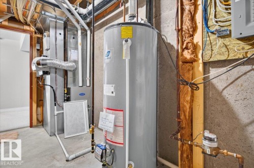 Water heater and furnace systems with visible piping and ductwork - #7 10500 103 Av, Morinville, AB 