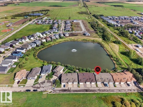 Pond-front property with a fountain feature - #7 10500 103 Av, Morinville, AB 