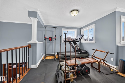 Upper-level space featuring crown molding, white trim, and multiple windows - 6904 18 Avenue Sw, Edmonton, AB 