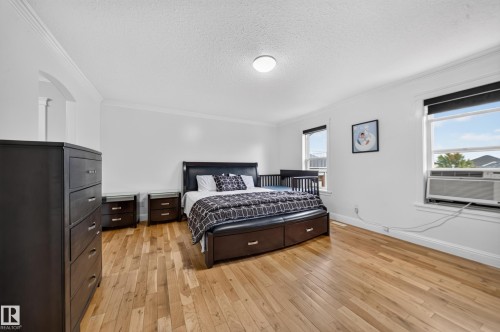 Hardwood-style flooring throughout with crown molding accents - 6904 18 Avenue Sw, Edmonton, AB 