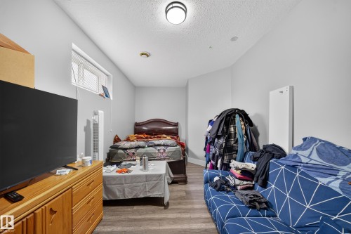Wood-finish flooring with light gray wall paint and a flush-mount ceiling light - 6904 18 Avenue Sw, Edmonton, AB 
