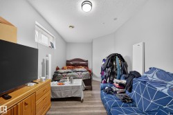 Wood-finish flooring with light gray wall paint and a flush-mount ceiling light - 