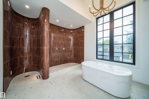 Curved tile shower enclosure featuring rich brown vertical tiles - 10414 134 Street Nw, Edmonton, AB 