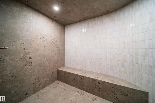 Recessed ceiling light, stone-finish walls, built-in stone bench, and curved tiled wall - 10414 134 Street Nw, Edmonton, AB 