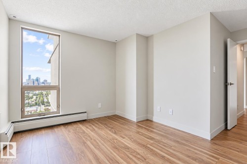 Wood-finish flooring, white trim, and a high ceiling - #2005 10149 Saskatchewan Dr Nw, Edmonton, AB 