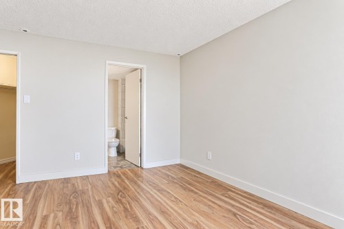 Wood-finish flooring throughout, smooth white ceilings, and light neutral wall paint - #2005 10149 Saskatchewan Dr Nw, Edmonton, AB 
