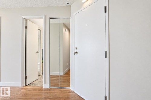 Wood-finish flooring with white baseboards - #2005 10149 Saskatchewan Dr Nw, Edmonton, AB 