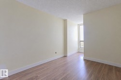 Wood-finish flooring, light-toned wall paint, white trim, and a prominent window - 