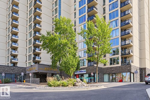 High-rise building with a stone-clad base and multiple levels of individual balconies featuring glass railings - #2005 10149 Saskatchewan Dr Nw, Edmonton, AB 