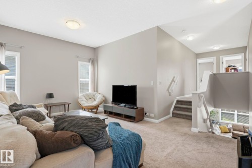 Living area featuring neutral wall tones, carpeted flooring, and recessed lighting - 3204 Abbott Crescent Sw, Edmonton, AB - Indoor Photo Showing Living Room