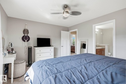 Bedroom featuring light gray walls and a ceiling fan with integrated lighting - 3204 Abbott Crescent Sw, Edmonton, AB - Indoor Photo Showing Bedroom