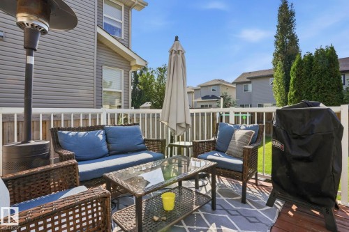 Expansive wood-finish deck featuring white spindle railing and a privacy fence - 3204 Abbott Crescent Sw, Edmonton, AB - Outdoor With Deck Patio Veranda With Exterior