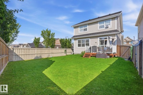 Spacious backyard with a large lawn, private fencing, and a multi-level wood deck - 3204 Abbott Crescent Sw, Edmonton, AB - Outdoor With Deck Patio Veranda