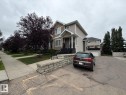 Two-story exterior with siding, a front porch, and an attached garage - #85 9535 217 St Nw, Edmonton, AB 