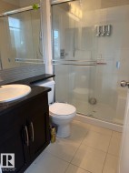 Dark wood-finish vanity with a white vessel sink and dark countertop - 