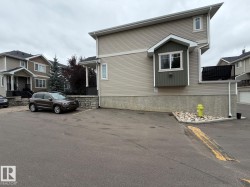 Exterior featuring a bay window, composite siding, and a stone retaining wall - 