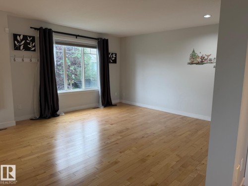 Hardwood flooring throughout, recessed lighting, and a large multi-pane window - #85 9535 217 St Nw, Edmonton, AB 