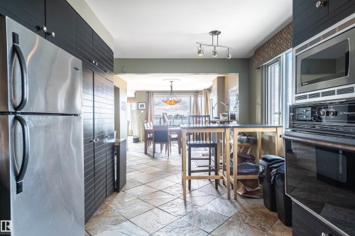 Stainless steel refrigerator, integrated built-in microwave, and oven - #1202 10010 119 St Nw, Edmonton, AB 