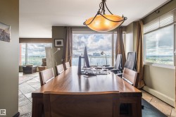 Expansive windows with roller shades, a bronze-finish chandelier, and tile flooring - 