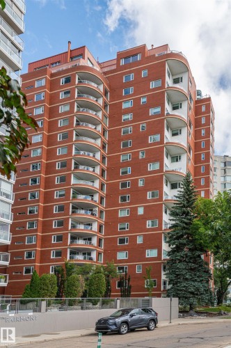 Multi-story building featuring a brick facade, numerous balconies with glass railings, and a prominent "FAIRMONT" sign on the exterior wall - #1202 10010 119 St Nw, Edmonton, AB 
