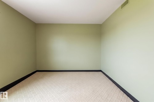 Light green walls with black trim, and patterned carpet - #1202 10010 119 St Nw, Edmonton, AB 