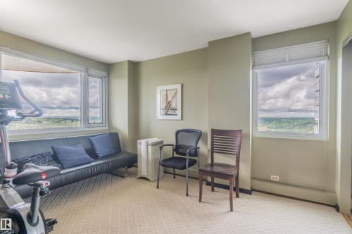 Wall-to-wall patterned carpeting, light green painted walls, and white trim - #1202 10010 119 St Nw, Edmonton, AB 
